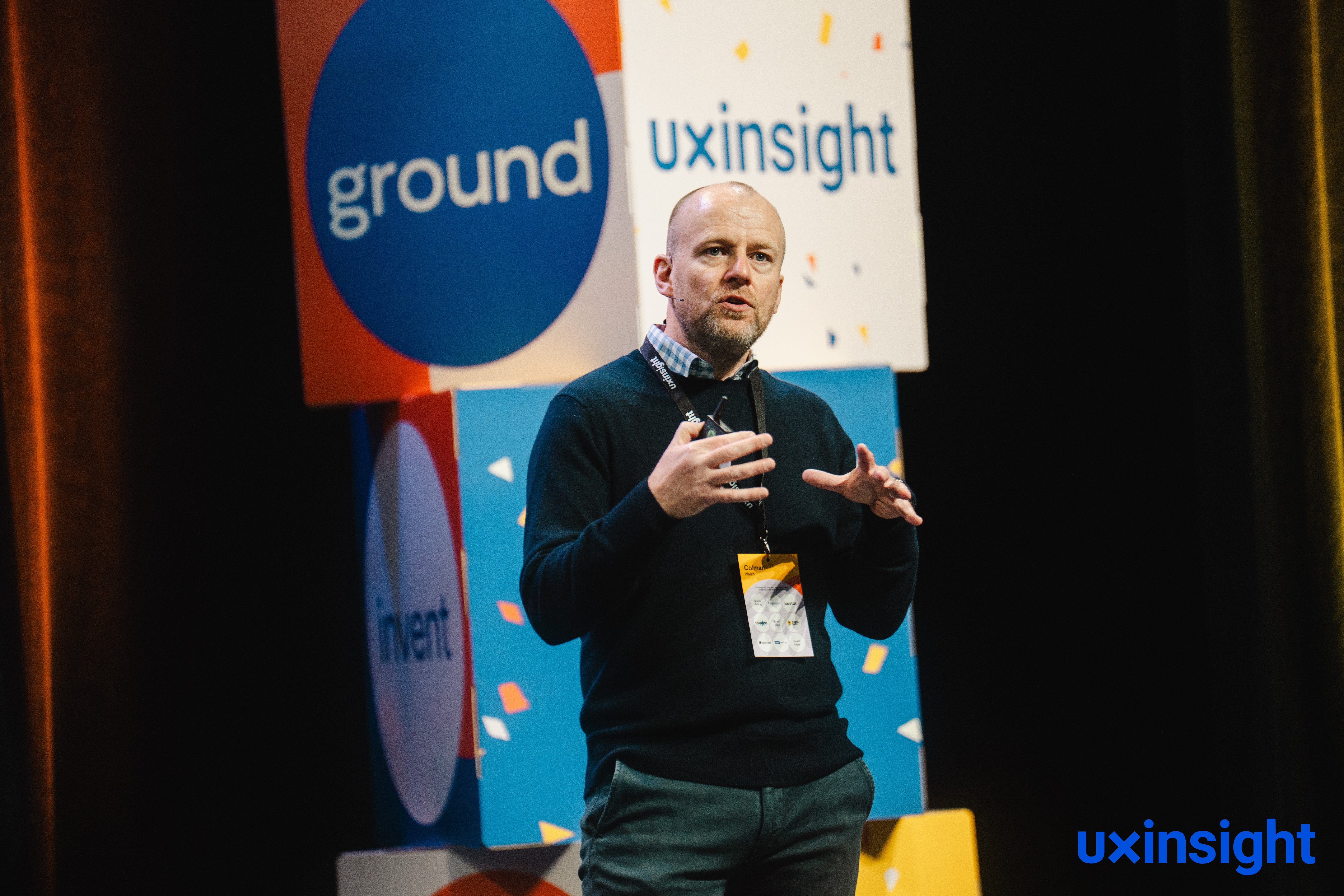 Colman Walsh speaking on stage at UX Insight